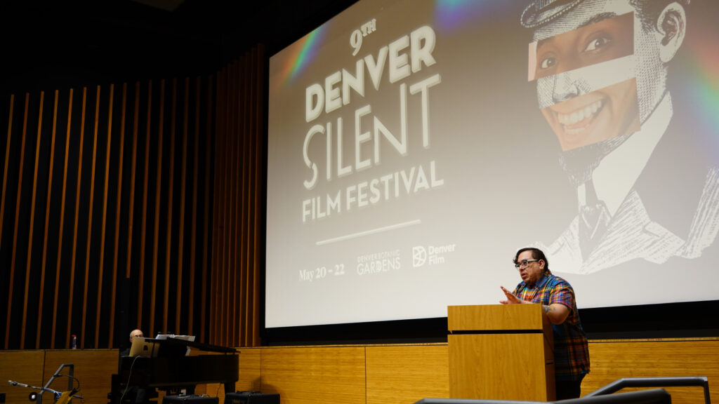 Speaker at podium during Denver Silent Film Festival presentation