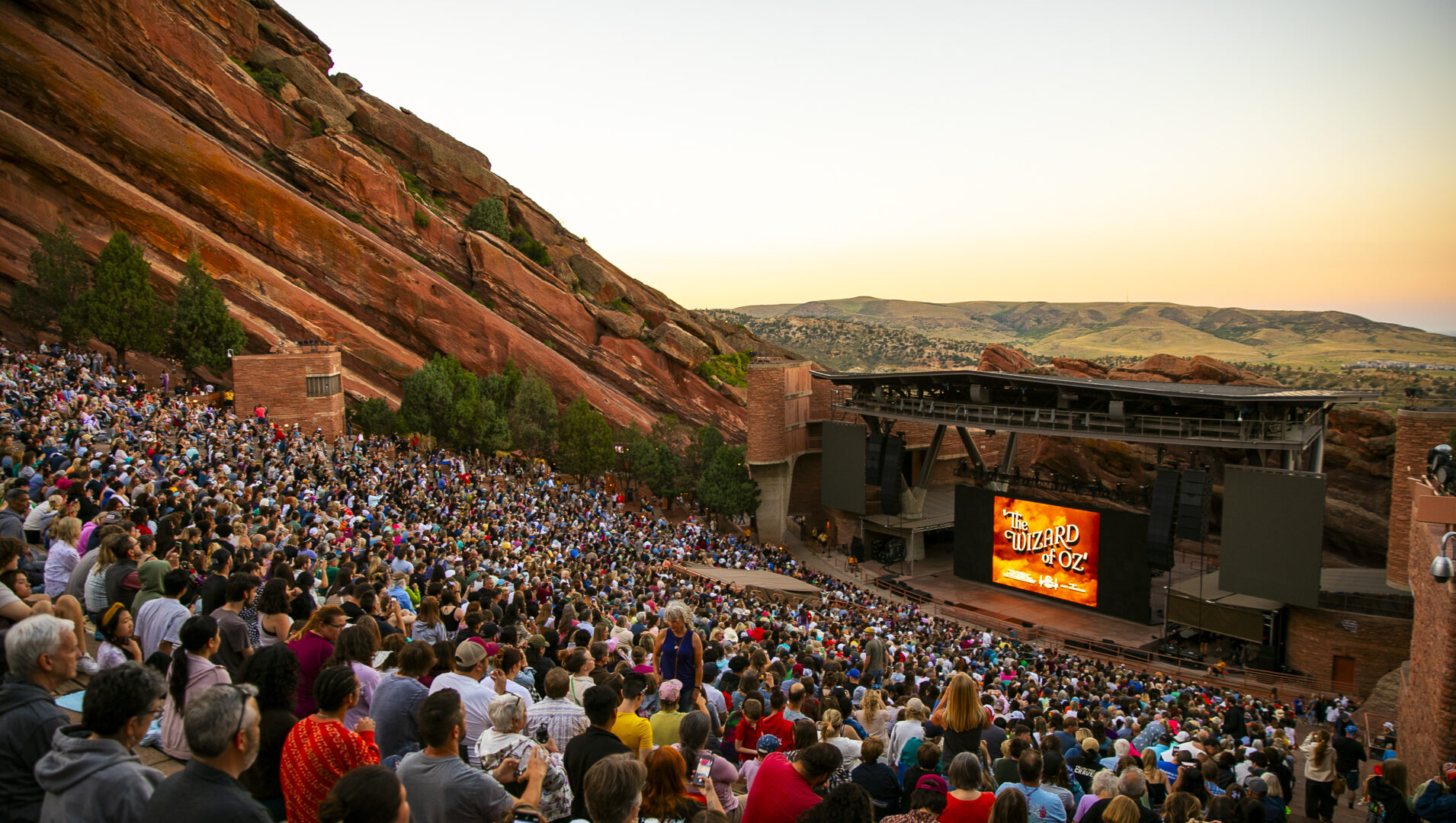 Crowd at Red Rocks Amphitheatre watching "The Wizard of Oz" at sunset