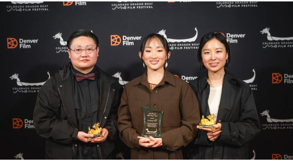 Three people holding awards at the Colorado Dragon Boat Film Festival