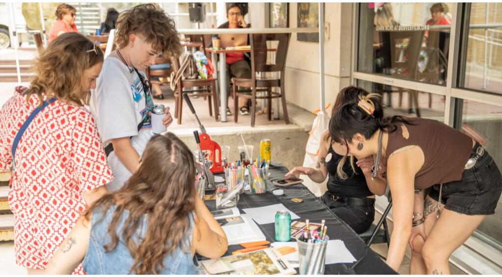 Group of people engaged in a creative art activity at a table