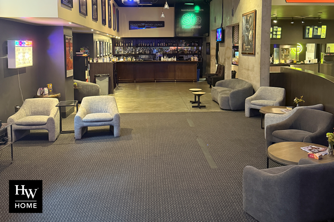 Henderson-Withey Lounge featuring modern seating, bar, and neon sign. HW Home logo