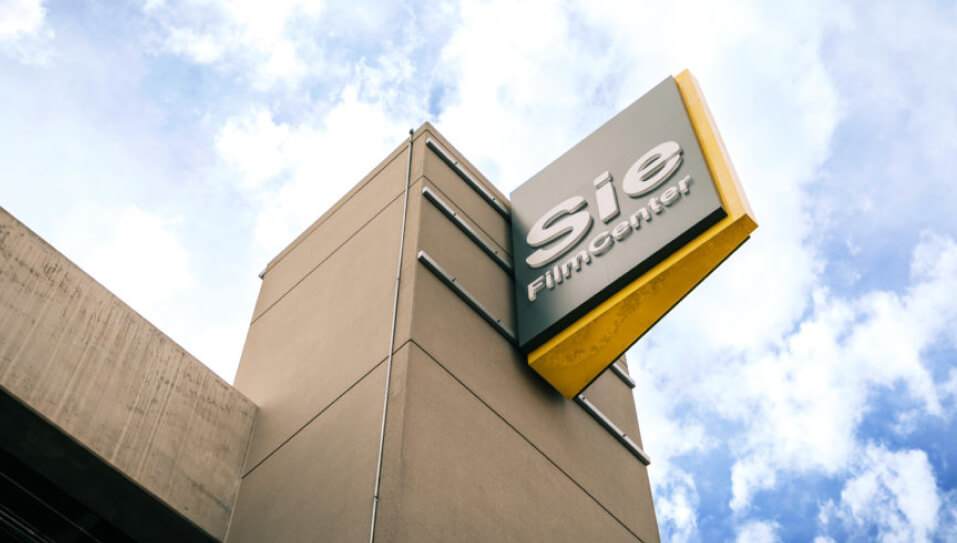 Sie FilmCenter sign on a building against a blue sky