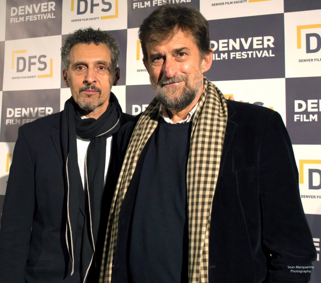 Two men smiling at the Denver Film Festival backdrop