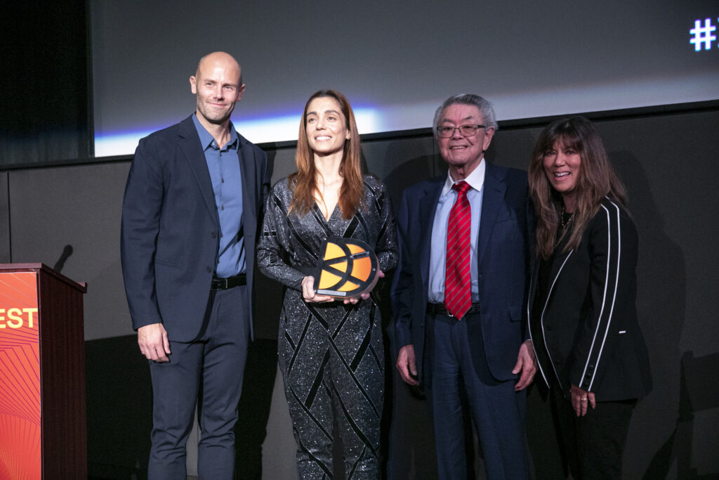 Christiana Dell'Anna holding an award with three others at film festival
