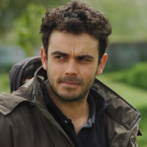 Federico Bondi looking pensive outdoors, wearing a dark jacket