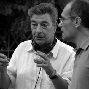 Gianni engages in a focused conversation with a colleague