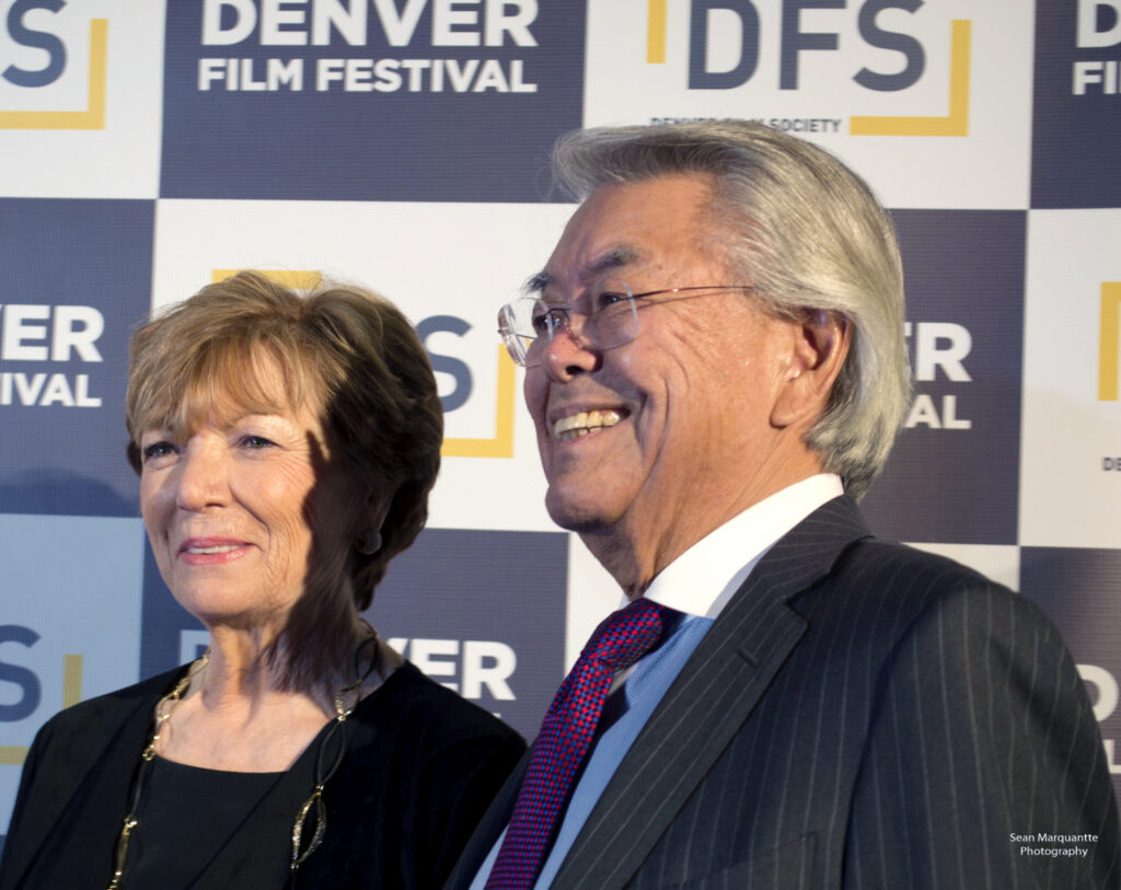 Marquantte at Denver Film Festival smiling on red carpet, promotional backdrop behind them