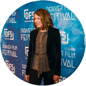 Staff-1 is smiling on Denver Film Festival backdrop