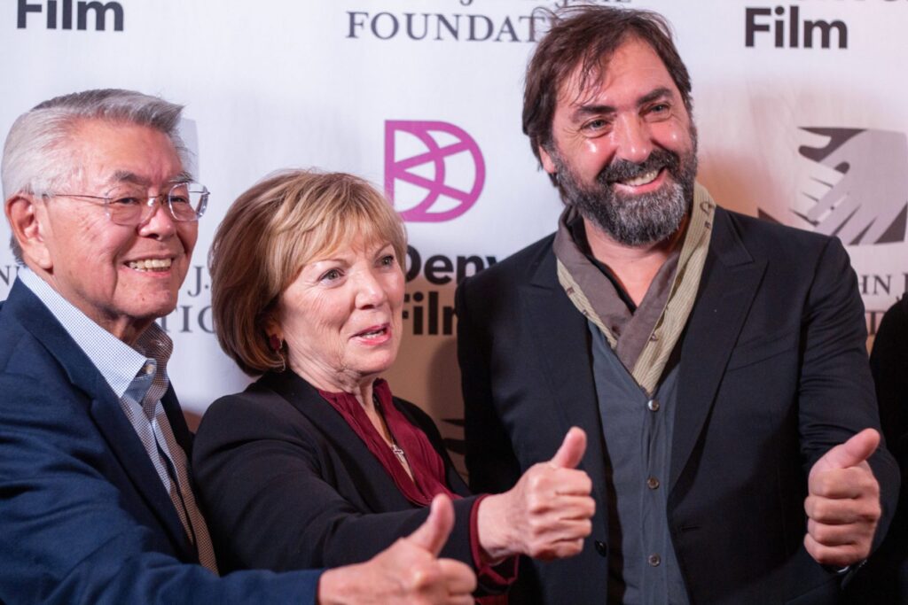 Stefano Mordini and guests smiling, giving thumbs up at Denver Film Festival red carpet event