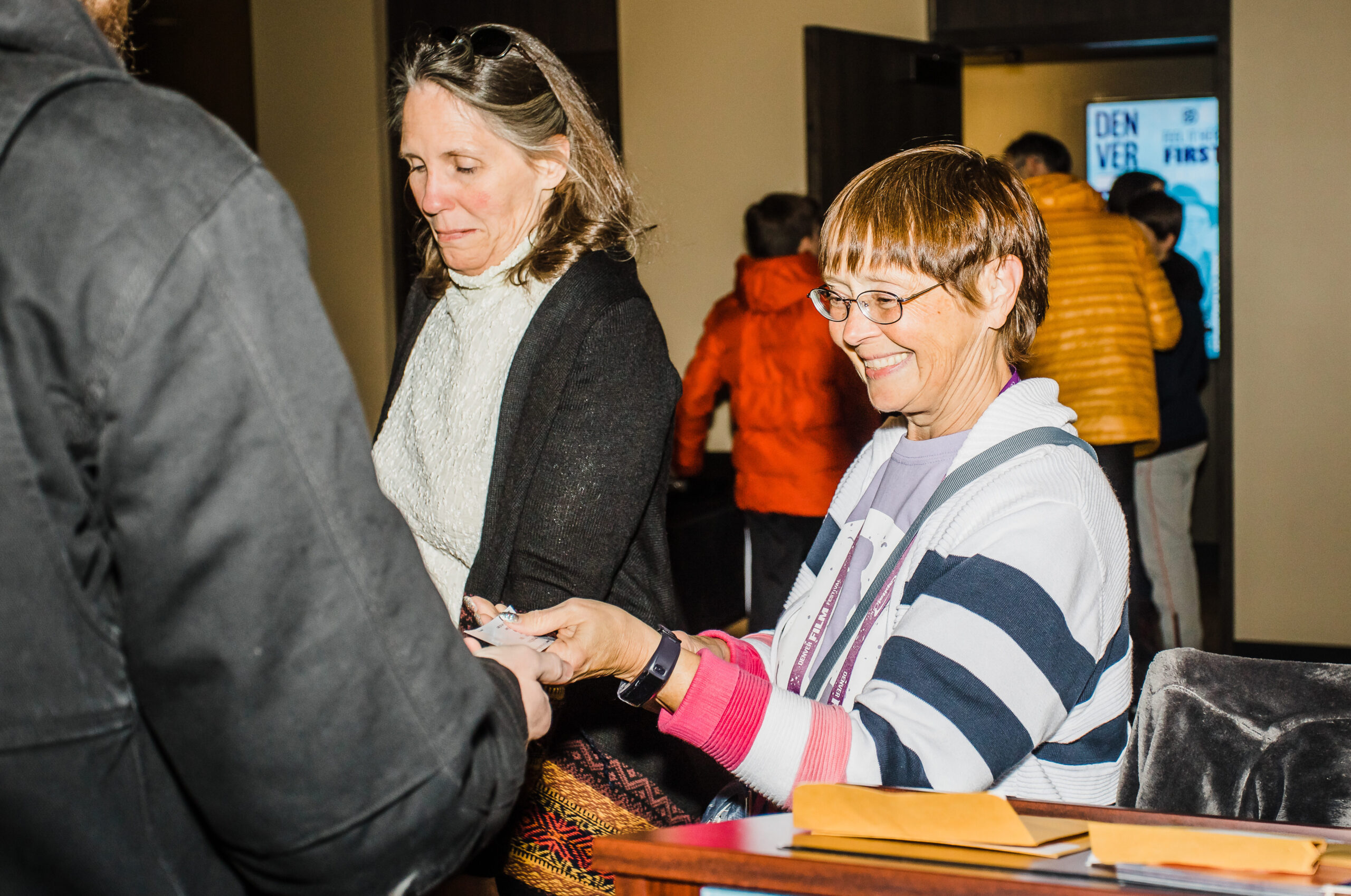 Support-Individual-Giving event with two women interacting warmly, exchanging items
