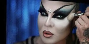 The-Heels-Have-Eyes: Person applying dramatic makeup with bold eyeshadow