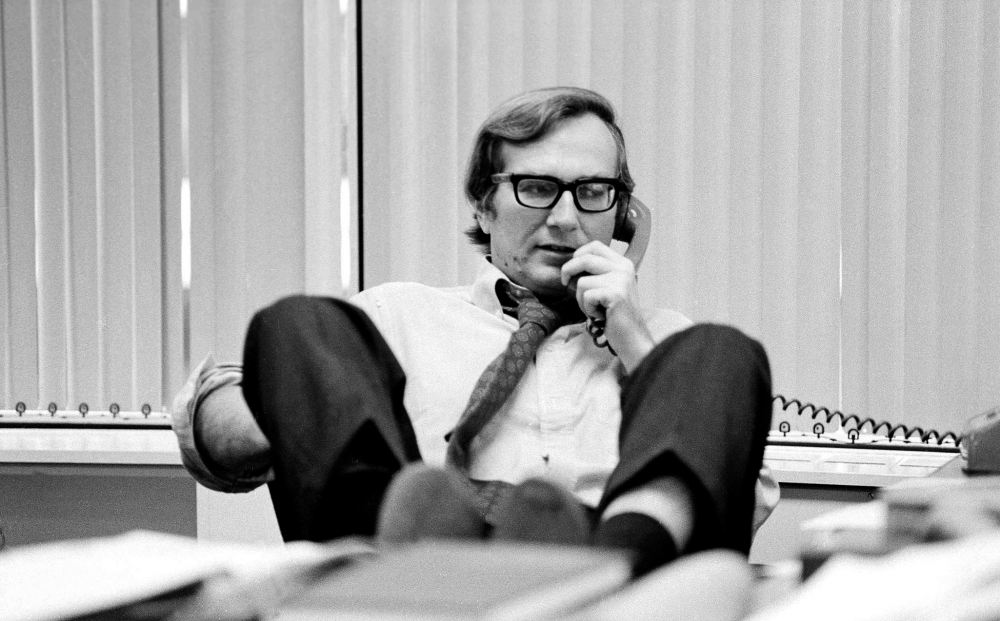 [gpt-4o]: Person in an office, feet up on desk, talking on phone, looking contemplative