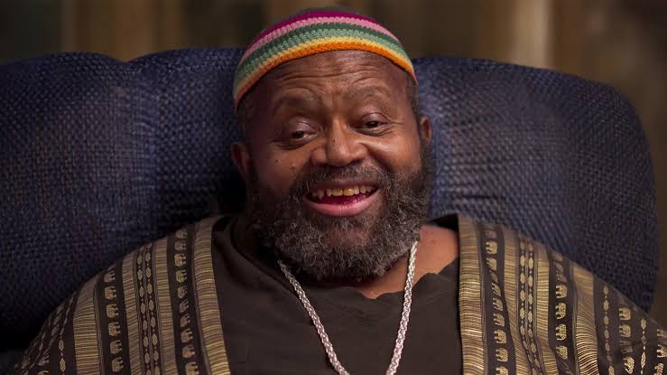 [gpt-4o]: Person in colorful cap smiling warmly, wearing patterned attire