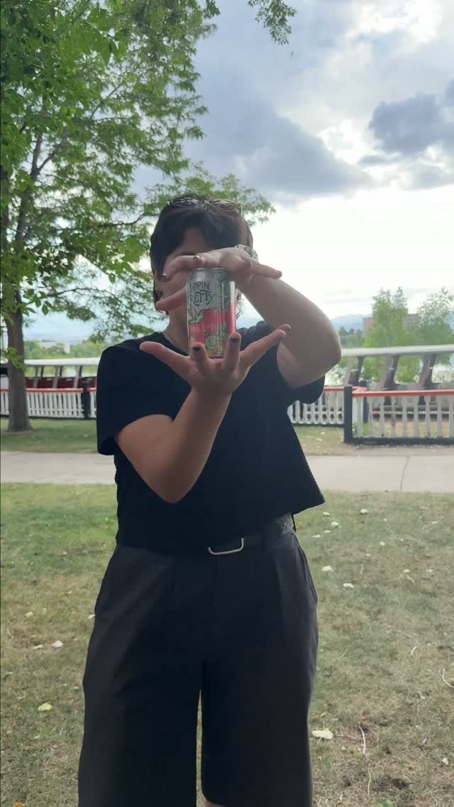 Person outdoors holding a "Trippin Perry" can with cloudy sky and trees in the background [Model: gpt-4o]