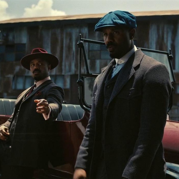 [gpt-4o]: Two men in vintage suits by a car, one gesturing assertively
